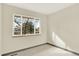 Bedroom featuring neutral paint and carpet, and a view of trees outside the window at 12933 E Louisiana Ave, Aurora, CO 80012