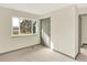 Bedroom featuring neutral paint and carpet, with a large closet and outdoor view at 12933 E Louisiana Ave, Aurora, CO 80012