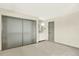 The bedroom features a large closet, ensuite bathroom and neutral carpeting at 12933 E Louisiana Ave, Aurora, CO 80012
