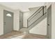 An inviting home entryway featuring hardwood floors and a modern staircase with black metal railings at 12933 E Louisiana Ave, Aurora, CO 80012