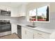 A bright kitchen with stainless steel appliances, quartz countertops, and modern fixtures at 12933 E Louisiana Ave, Aurora, CO 80012