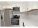Bright kitchen featuring stainless steel appliances, white cabinetry, and quartz countertops at 12933 E Louisiana Ave, Aurora, CO 80012