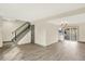 Open living space with hardwood floors, a modern staircase, and sliding glass doors to the outdoors at 12933 E Louisiana Ave, Aurora, CO 80012