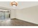 An open living area features wood flooring, a glass sliding door, and a unique ceiling light fixture at 12933 E Louisiana Ave, Aurora, CO 80012