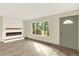 Bright living room with wood-look floors, a modern fireplace, and large windows offering an outdoor view at 12933 E Louisiana Ave, Aurora, CO 80012