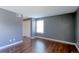Bedroom with hardwood floors, closet, and natural light from a single window at 14204 E 1St Dr # A12, Aurora, CO 80011