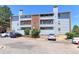 Three-story condo featuring pale-blue siding and brick accents on a sunny day at 14204 E 1St Dr # A12, Aurora, CO 80011