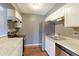 Kitchen featuring stainless steel appliances, granite countertops, and white cabinets at 14204 E 1St Dr # A12, Aurora, CO 80011