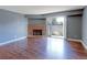 Living room with hardwood floors, a brick fireplace, and sliding doors to a patio at 14204 E 1St Dr # A12, Aurora, CO 80011