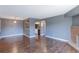 Open-concept living room with hardwood floors, fireplace, and view into the kitchen at 14204 E 1St Dr # A12, Aurora, CO 80011