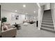 Finished basement with neutral carpet, recessed lighting, and a comfortable living space at 3565 S Holly St, Denver, CO 80237