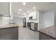 Bright kitchen featuring stainless steel appliances, granite countertops, and gray tile flooring at 3565 S Holly St, Denver, CO 80237