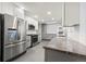 Modern kitchen featuring stainless steel appliances, granite countertops, and ample cabinet space at 3565 S Holly St, Denver, CO 80237