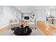 Spacious living area featuring hardwood floors, comfortable seating, neutral decor, and an open layout at 3565 S Holly St, Denver, CO 80237