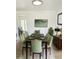 Bright dining room features a wood table with seating for eight, stylish lighting, and modern decor at 5986 S Cook St, Centennial, CO 80121
