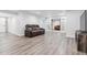 Finished basement with gray wood flooring and a comfortable reclining sofa at 10288 Olathe Way, Commerce City, CO 80022