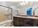 Bathroom with double vanity, framed mirrors, and a glass enclosed shower at 10288 Olathe Way, Commerce City, CO 80022