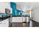 Modern kitchen boasts stainless steel appliances, sleek countertops, and an open layout for easy entertaining at 10288 Olathe Way, Commerce City, CO 80022