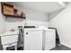 Laundry room featuring a utility sink and a modern washer and dryer at 10288 Olathe Way, Commerce City, CO 80022