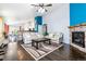 Open-concept layout showcasing living room with stone accent wall and seamless flow into the kitchen and dining areas at 10288 Olathe Way, Commerce City, CO 80022