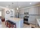 Modern kitchen with gray cabinets, granite countertops, and stainless steel appliances at 10983 Uvalda St, Commerce City, CO 80022