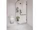 Modern bathroom with walk-in shower, toilet, and floating shelves at 4642 Tennyson St # 26, Denver, CO 80211