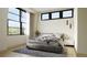 Spacious bedroom with large windows and gray bedding at 4642 Tennyson St # 26, Denver, CO 80211