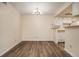 Bright dining area featuring wood-look floors, a modern chandelier, and adjacent kitchen space at 3412 S Eagle St # 202, Aurora, CO 80014