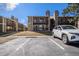 Lovely exterior view of a well-maintained apartment building with balconies, stone accents, and parking spaces at 3412 S Eagle St # 202, Aurora, CO 80014