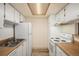 Functional kitchen layout with white appliances and wooden countertops at 3412 S Eagle St # 202, Aurora, CO 80014