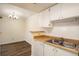 Well lit kitchen with wooden countertops, white cabinets, and stainless steel sink at 3412 S Eagle St # 202, Aurora, CO 80014