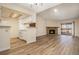 Living room that opens to the kitchen, plus a stone fireplace and sliding glass door at 3412 S Eagle St # 202, Aurora, CO 80014