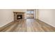 Bright living room showcasing wood-look floors, a stone fireplace, and sliding doors to the outdoor space at 3412 S Eagle St # 202, Aurora, CO 80014