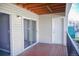 Balcony with red deck, glass doors, and neutral vinyl siding at 12158 W Dorado Pl # 204, Littleton, CO 80127