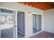 Balcony with red deck, glass doors, and vinyl siding at 12158 W Dorado Pl # 204, Littleton, CO 80127