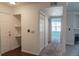 An entryway with laminate flooring, a closet, and view to the living room and other rooms in the unit at 12158 W Dorado Pl # 204, Littleton, CO 80127