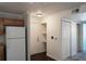 Hallway with laminate flooring, a closet, and view to the kitchen appliances and cabinets at 12158 W Dorado Pl # 204, Littleton, CO 80127