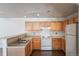 The eat-in kitchen features wood cabinets and track lighting at 12158 W Dorado Pl # 204, Littleton, CO 80127