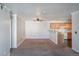 Open living room and kitchen layout featuring neutral carpet and updated oak cabinetry at 12158 W Dorado Pl # 204, Littleton, CO 80127