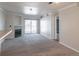 A spacious living room featuring a fireplace, neutral carpeting, and sliding glass doors to the outside at 12158 W Dorado Pl # 204, Littleton, CO 80127