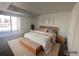 A staged main bedroom boasts a walk-out balcony and natural light at 12158 W Dorado Pl # 204, Littleton, CO 80127