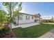 Serene backyard featuring a well-maintained lawn and a cozy covered patio at 27957 E 9Th Dr, Aurora, CO 80018