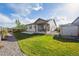 Picturesque backyard with lush green grass, patio, and convenient access to the house at 27957 E 9Th Dr, Aurora, CO 80018