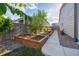 Landscaped yard features raised garden beds with flourishing plants at 27957 E 9Th Dr, Aurora, CO 80018