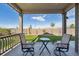 Relaxing covered patio with stylish seating and a picturesque view of the fenced backyard at 27957 E 9Th Dr, Aurora, CO 80018