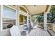 Back porch with lots of windows, chairs and a view of the water at 1738 Edgewater Pl, Longmont, CO 80504