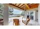 Covered patio with a swing, outdoor seating, and serene lake views at 1738 Edgewater Pl, Longmont, CO 80504