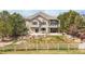 Beautifully landscaped backyard with mature trees and a view of the home's two-story design at 1738 Edgewater Pl, Longmont, CO 80504