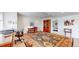 Finished basement offering a desk, chair, cabinet, and large oriental rug at 1738 Edgewater Pl, Longmont, CO 80504