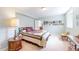 Serene bedroom features a large bed, wooden dresser, and comfortable seating space with charming decor at 1738 Edgewater Pl, Longmont, CO 80504